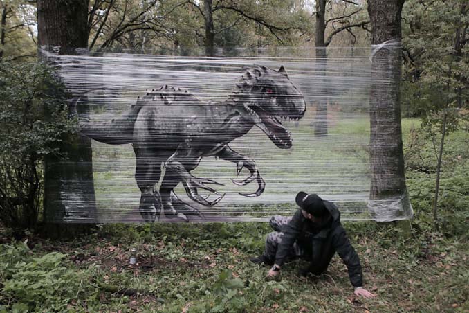 Καλλιτέχνης ζωγραφίζει ζώα στο δάσος με σπρέι πάνω σε διάφανη μεμβράνη (1)